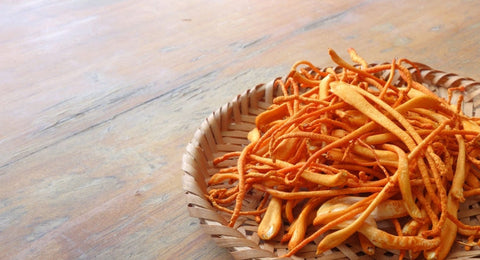 dried cordyceps mushrooms on a wicker plate